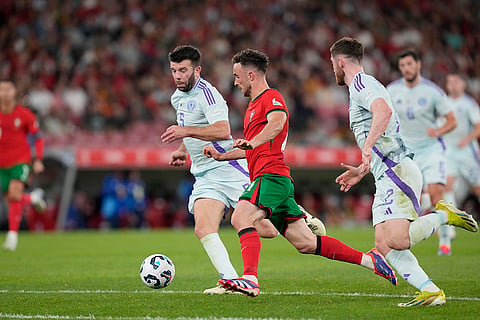 2024–25 UEFA Nations League, Portugal vs Scotland: Portugal's Diogo Jota, centre, challenges for the ball with Scotland's Grant Hanley, left, and Anthony Ralston 
